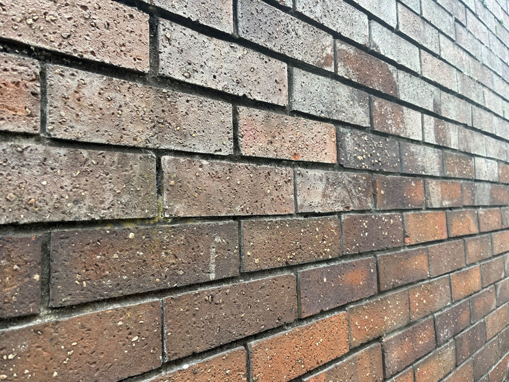 Water soaking through brick wall